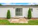 Patio with sliding glass doors framed by landscaping trees and pea gravel at 4640 Autumn Ridge Dr, Columbus, IN 47203