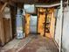 Utility area in basement with hot water heater, furnace, and storage racks offering space for essential systems at 4853 Wentworth Blvd, Indianapolis, IN 46201