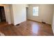 Bright bedroom with hardwood floors and a window bringing in natural light at 4853 Wentworth Blvd, Indianapolis, IN 46201