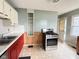 View of the kitchen showcasing stainless steel stove and vintage cabinetry at 4853 Wentworth Blvd, Indianapolis, IN 46201