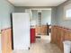 Spacious kitchen with refrigerator, stainless appliances, and vintage details at 4853 Wentworth Blvd, Indianapolis, IN 46201