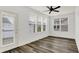 Sunroom filled with natural light features wood floors and several windows at 5125 Lilium Dr, Plainfield, IN 46168