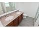 Bathroom features double vanity with granite countertop and grey flooring at 5151 Climbing Rose Pl, Indianapolis, IN 46254
