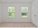 Bright bedroom features two windows and neutral carpet at 5151 Climbing Rose Pl, Indianapolis, IN 46254