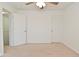 Bedroom with white walls, a ceiling fan, and two doors leading to other rooms, offering a versatile living space at 5151 Climbing Rose Pl, Indianapolis, IN 46254