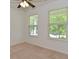 Bedroom featuring neutral carpet, two windows, and bright white walls at 5151 Climbing Rose Pl, Indianapolis, IN 46254