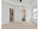 Bedroom features neutral carpet and doors to closets and ensuite at 5151 Climbing Rose Pl, Indianapolis, IN 46254