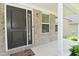 View of front porch showing front door, large sidelight window, and brick exterior at 5151 Climbing Rose Pl, Indianapolis, IN 46254
