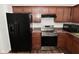 Modern kitchen with black appliances, wooden cabinets and countertops, and hardwood floors at 5151 Climbing Rose Pl, Indianapolis, IN 46254