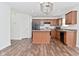 Modern kitchen with wooden cabinets, a center island, and stainless steel appliances, perfect for cooking and entertaining at 5151 Climbing Rose Pl, Indianapolis, IN 46254