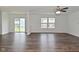 Open living area with hardwood flooring, ample natural light, and a view of the backyard at 5151 Climbing Rose Pl, Indianapolis, IN 46254