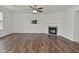 Spacious living room featuring hardwood floors, a modern fireplace, and a wall-mounted TV bracket at 5151 Climbing Rose Pl, Indianapolis, IN 46254