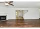 Bright living room with hardwood floors, a cozy fireplace, and an open view into the foyer at 5151 Climbing Rose Pl, Indianapolis, IN 46254