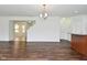 Inviting living room showcases an open floor plan with wood flooring, staircase and contemporary lighting at 5151 Climbing Rose Pl, Indianapolis, IN 46254