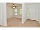 A bright living room featuring neutral carpet, ample natural light, and a view of the home's entry at 5151 Climbing Rose Pl, Indianapolis, IN 46254