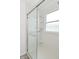 Shower features glass door and white tiled surround at 5151 Climbing Rose Pl, Indianapolis, IN 46254