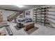 Finished basement offering a relaxation space with comfortable seating and a staircase at 5306 N Kenwood Ave, Indianapolis, IN 46208