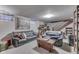 Finished basement featuring comfortable seating, a staircase, and natural light from window at 5306 N Kenwood Ave, Indianapolis, IN 46208