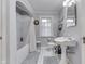 Well-lit bathroom with a shower-tub combo, white fixtures, and a window for ventilation at 5306 N Kenwood Ave, Indianapolis, IN 46208