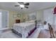 Cozy bedroom featuring a ceiling fan, hardwood floors, and complemented by elegant white trim at 5306 N Kenwood Ave, Indianapolis, IN 46208