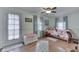 Airy bedroom with multiple windows and a door, complemented by light-colored walls and hardwood flooring at 5306 N Kenwood Ave, Indianapolis, IN 46208