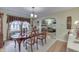 Dining room featuring wood floors, large window, and classic decor and arched entry at 5306 N Kenwood Ave, Indianapolis, IN 46208