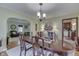 Open concept view of the dining room with a dark wood table and chairs at 5306 N Kenwood Ave, Indianapolis, IN 46208
