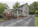 Charming two-story home featuring a well-maintained exterior, asphalt driveway and a side deck at 5306 N Kenwood Ave, Indianapolis, IN 46208