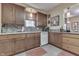 Well-lit kitchen with granite countertops, backsplash, wooden cabinets, and modern appliances at 5306 N Kenwood Ave, Indianapolis, IN 46208