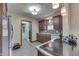 Spacious kitchen featuring dark wood cabinets, gray tile floors, and modern appliances at 5306 N Kenwood Ave, Indianapolis, IN 46208