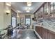Charming kitchen area featuring wooden cabinets, a breakfast nook, and natural light at 5306 N Kenwood Ave, Indianapolis, IN 46208