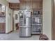 Stainless steel refrigerator and double ovens, with wood cabinets, in this well-appointed kitchen at 5306 N Kenwood Ave, Indianapolis, IN 46208