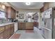 Bright kitchen with wooden cabinets, gray tile floors, modern appliances, and a functional layout at 5306 N Kenwood Ave, Indianapolis, IN 46208