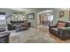 Cozy living room featuring hardwood floors, a floral rug, and comfortable leather furniture at 5306 N Kenwood Ave, Indianapolis, IN 46208