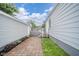 The backyard shows a brick paver patio and a pathway to stairs leading to the home's side entrance at 564 S Bosart Ave, Indianapolis, IN 46203