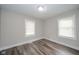 Bright bedroom with new flooring, fresh neutral paint, and natural light at 564 S Bosart Ave, Indianapolis, IN 46203