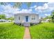 Charming single-story home with a bright blue door, landscaped front yard, and inviting curb appeal at 564 S Bosart Ave, Indianapolis, IN 46203
