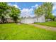 The property showcases a detached one-car garage and an adjacent home, set on a lawn at 564 S Bosart Ave, Indianapolis, IN 46203