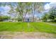 This home features a lush front yard and is partially obscured by trees at 564 S Bosart Ave, Indianapolis, IN 46203