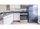 Updated kitchen featuring stainless steel appliances, white cabinets, and plenty of storage space at 564 S Bosart Ave, Indianapolis, IN 46203