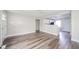 A bright living room with wood-look flooring and an open concept view into the kitchen at 564 S Bosart Ave, Indianapolis, IN 46203