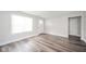 Well-lit living room features sleek flooring, white trim, and ample space for comfortable living at 564 S Bosart Ave, Indianapolis, IN 46203