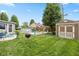 Spacious backyard featuring a wooden deck with seating area, fire pit, an above ground pool and shed at 580 Northgate Dr, Greenwood, IN 46143
