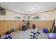 Finished basement with home gym featuring workout equipment, mirrors, and two windows at 580 Northgate Dr, Greenwood, IN 46143