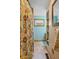 This bathroom features a paisley shower curtain, window with white curtain, and open shelving at 580 Northgate Dr, Greenwood, IN 46143