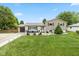 Charming home with a well-manicured lawn, a stone walkway and a cozy front porch seating area at 580 Northgate Dr, Greenwood, IN 46143