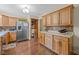 Spacious kitchen with stainless steel refrigerator, wood cabinets, counterspace, and tile backsplash at 580 Northgate Dr, Greenwood, IN 46143