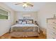 Comfortable bedroom with wood flooring, ceiling fan and a large bed with decorative pillows at 580 Northgate Dr, Greenwood, IN 46143