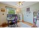 This home office includes a large desk, office chair, shelving, and a window for natural light at 580 Northgate Dr, Greenwood, IN 46143