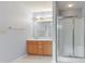 Bright bathroom featuring a double sink vanity with a glass-enclosed shower at 5852 Long Ridge Pl, Indianapolis, IN 46221